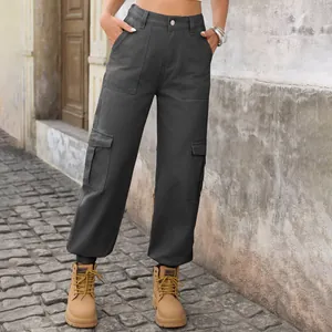 Detail view of dark grey washed cargo denim trousers with multiple pockets and tapered cuffs