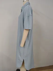 Side view detail of a loose light blue washed denim short-sleeved maxi shirt dress.