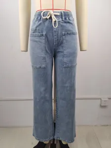 Washed blue denim pants with drawstring waist and large front pockets on mannequin.