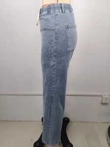 Side view detail of high-waist washed denim jeans with elastic drawstring waistband.