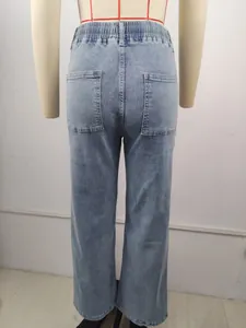 Back view of high-waist light blue denim jeans with elastic waistband and pockets.