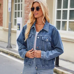 Detailed outdoor street style of a women's washed blue denim jacket with front pockets
