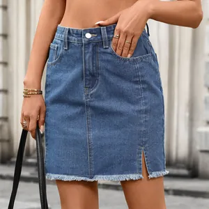 Detail of blue washed denim mini skirt with side slit and frayed hem.