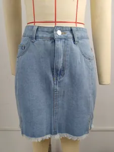 Front view of washed blue denim mini skirt with frayed hem and side slits
