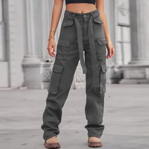 Close-up detail of high-waisted washed denim cargo pants with multiple utility pockets