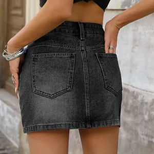Détail de l'arrière d'une mini-jupe en jean noir délavé avec poches et taille haute