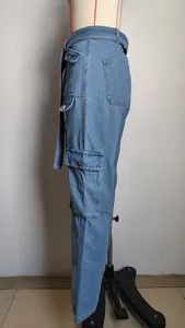 Close-up detail view of light blue denim cargo pants with side utility pockets and belt