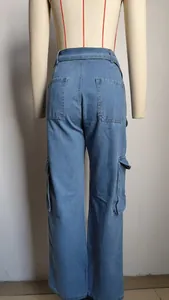 Detail view of washed blue denim cargo pants with multi-pockets and belt
