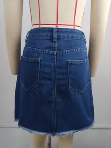 Back detail view of a washed blue denim short skirt with raw hem.