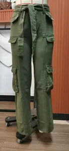 Detail view of olive green washed denim cargo pants with multiple functional pockets