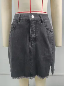 Detailed view of high waisted washed black denim mini skirt with side slit and raw hem