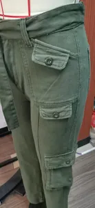 Detailed view of army green washed denim cargo pants with heavy-duty multi-pocket design