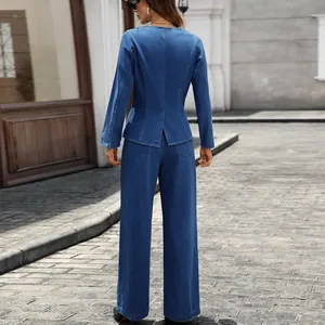 Back view of a stylish blue denim blazer and wide-leg trouser set in an urban setting.