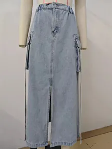 Front view of light wash denim cargo maxi skirt featuring elastic waist and high slit