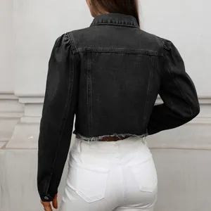 Back view of a cropped black denim jacket with frayed hem and puff sleeves
