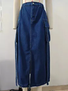 Detail of washed denim cargo maxi skirt with elastic waist and long decorative straps