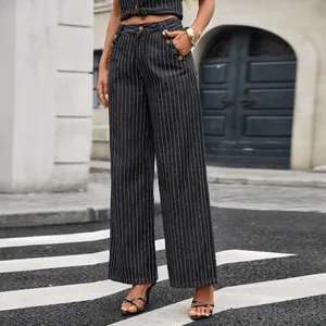 Detailed macro shot of women's pinstriped wide-leg denim trousers with gold button accents