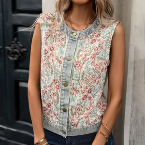 Detail view of vintage floral jacquard pattern on a casual denim-trimmed sleeveless vest