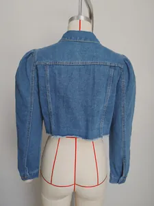 Detailed back view of women's washed blue cropped denim jacket with puff sleeves and raw hem