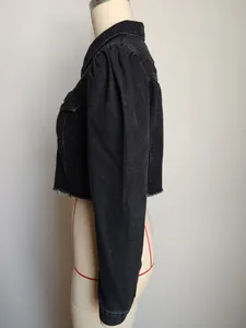 Side view of black cropped denim jacket featuring puff sleeves and frayed hem detail