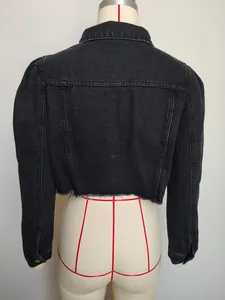 Back view of a black cropped denim jacket with puff sleeves and raw hem details