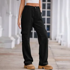 Detail view of women's black washed cargo pants with multiple pockets and elastic waist.