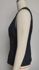 Side view showing pinstripe texture of a navy blue sleeveless denim vest garment.
