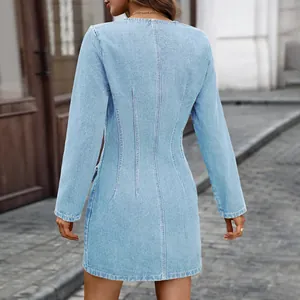Back view of a stylish light wash long sleeve denim mini dress with cinched waist detail