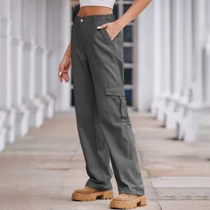 Close-up of grey washed denim cargo pants showing pocket details and high-waisted design.