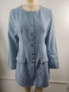 Front view of a light blue washed denim long sleeve dress with waist cinching on mannequin