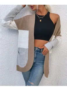 Dettaglio del cardigan in maglia color block con grandi tasche e orlo inferiore arrotondato.