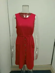 Close-up of a red sleeveless summer dress featuring a drawstring waist and buttons
