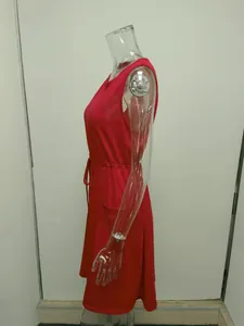 Side view detail of a vibrant red sleeveless tank dress featuring an adjustable drawstring waist