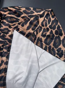 Detailed macro view of leopard print midi skirt fabric texture and hem stitching