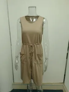 Detail view of khaki sleeveless dress featuring a drawstring waist and front buttons.