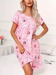 Detail view of pink crew neck nightgown featuring cute cartoon cat patterns and text