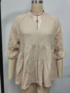 Vista frontale maglia beige scollo V con volant e orlo a balze su manichino professionale