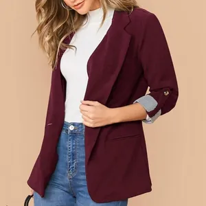 Dettaglio di un blazer bordeaux da donna con maniche risvoltate a righe e scollo a revers