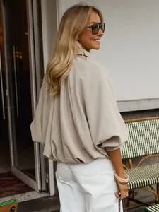 Detailed back view of a stylish loose cream white batwing sleeve jacket for women