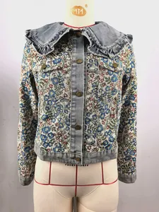 Detailaufnahme der Jeansjacke mit Blumentapisserie und Rüschenkragen