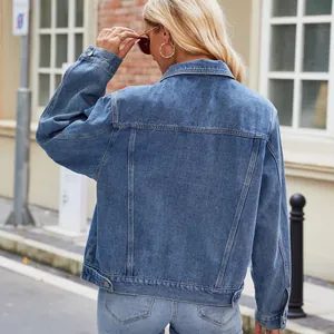 Back view of a classic blue slim fit washed denim jacket on a blonde model.