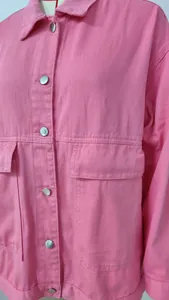 Close-up of pink denim jacket featuring silver buttons and chest pockets