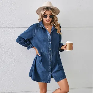 Full-length view of a loose washed denim midi dress with button detail on model