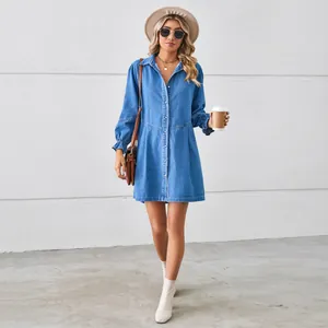 Close-up detail of a women's washed long-sleeve loose denim shirt dress with button front