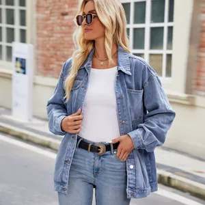 Stylish oversized light blue washed denim jacket for women in an urban street setting