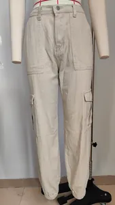 Front view of stylish beige cargo jeans featuring utility pockets and elastic cuffed ankles