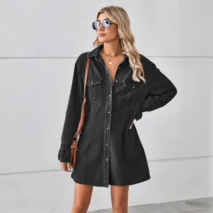 Outdoor full body shot of a loose black washed denim shirt dress with chest pockets