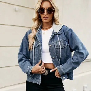 Stylish women's cropped denim jacket with a grey hoodie detail over a white top