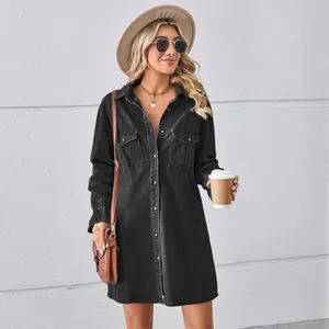 Stylish washed black denim shirt dress worn by model with hat and sunglasses