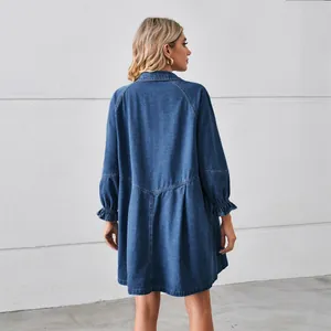 Back view of a long-sleeved washed denim mini dress featuring tiered stitching details